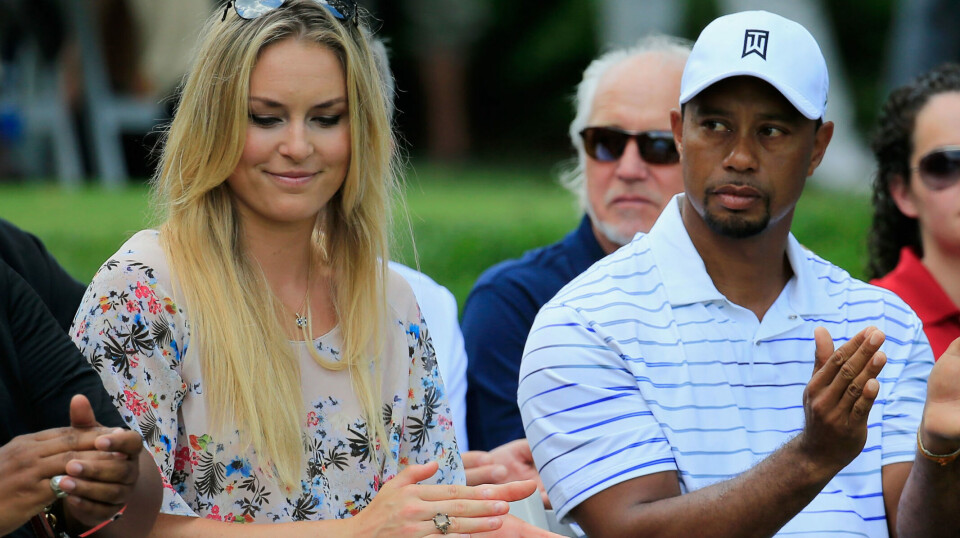 BETHESDA, MD - JUNE 25: Tiger Woods and girlfriend Lindsey Vonn applaud during the opening ceremony for the Quicken Loans National at Congressional Country Club on June 25, 2014 in Bethesda, Maryland. (Photo by Rob Carr/Getty Images)