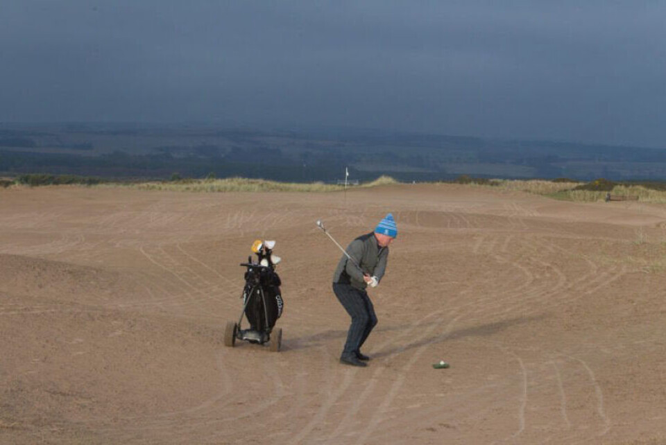 Historisk golfbane dekket av sand