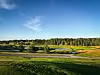 Etter store investeringer i klubbhus og driving range står banen nå for tur, forklarer ledelsen i Sandefjord GK – her med hull 18 i solnedgang.